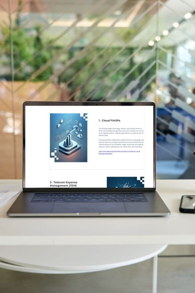 Open laptop on a white desk in a modern office, showing Universal Technology Solutions company website with headline text, an image of a man working in a server room, and company statistics.