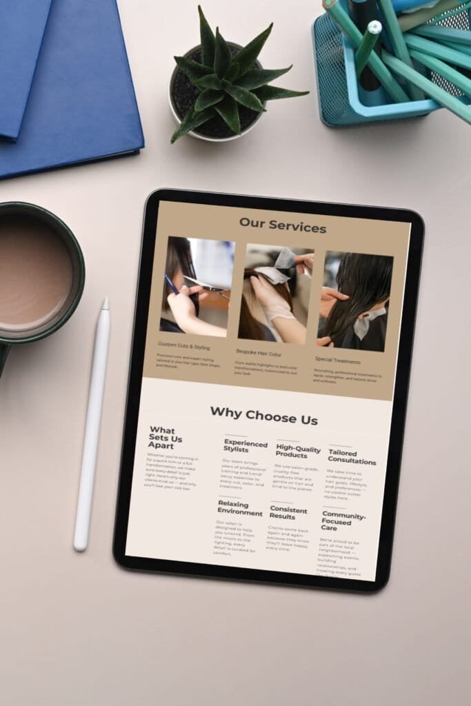 iPad showing Julie’s Hair Salon homepage, surrounded by coffee, plant, and office supplies on a clean desk.