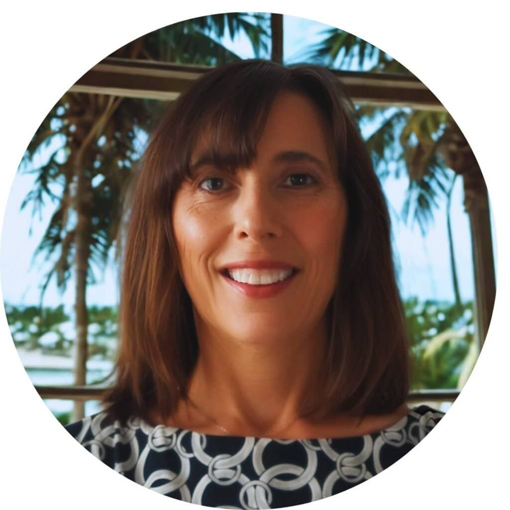 Close up of owner Sharon with Florida palm trees in the background